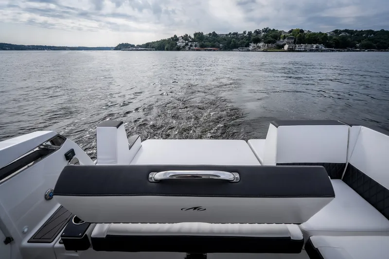 Slide: The Image of 2023 Monterey 378SS Super Sport boat on a serene lake with scenic shoreline. - 37
