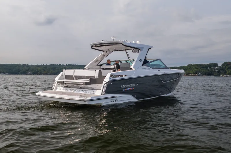 Slide: The Image of 2023 Monterey 378SS Super Sport boat cruising on a lake under a cloudy sky. - 4