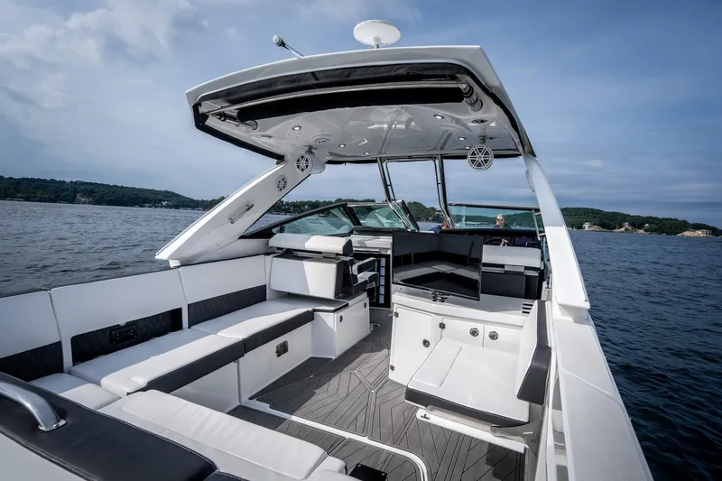 Slide: The Image of 2023 Monterey 378SS Super Sport boat interior on a lake, featuring sleek seating and modern design. - 8