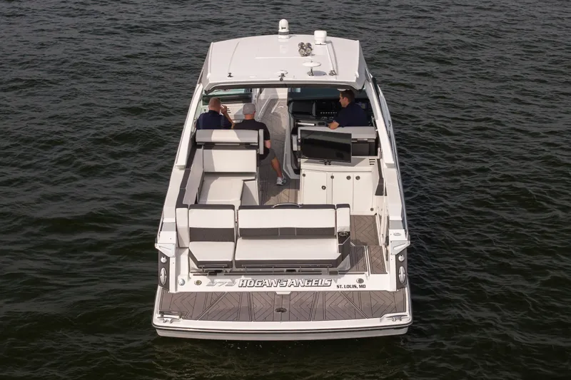 Slide: The Image of 2023 Monterey 378SS Super Sport boat cruising on water, rear view. - 2