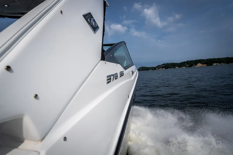 Slide: The Image of 2023 Monterey 378SS Super Sport boat cruising on a lake under a clear sky. - 50