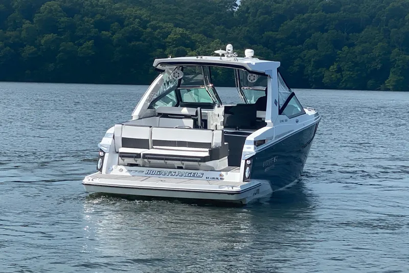 Slide: The Image of 2023 Monterey 378SS Super Sport boat cruising on a serene lake. - 10