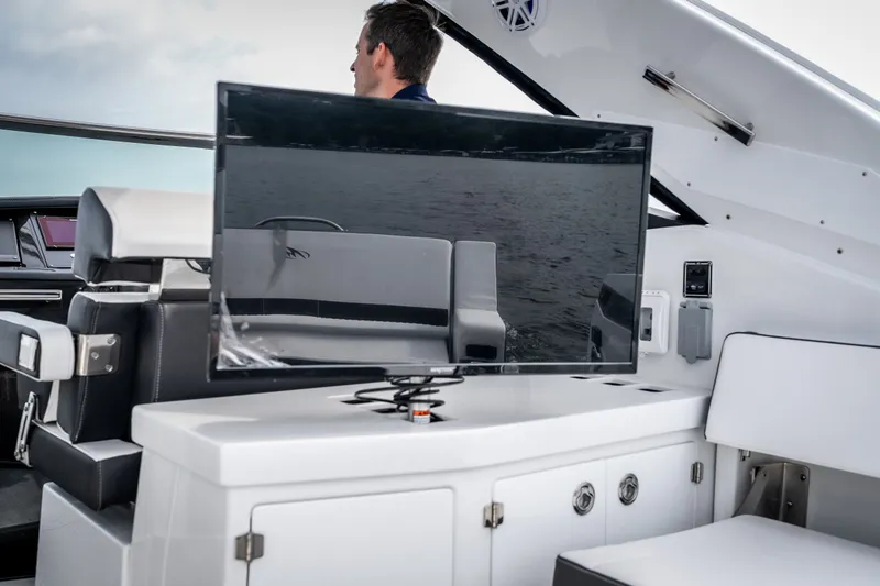 Slide: The Image of 2023 Monterey 378SS Super Sport boat interior with TV and seating area. - 34