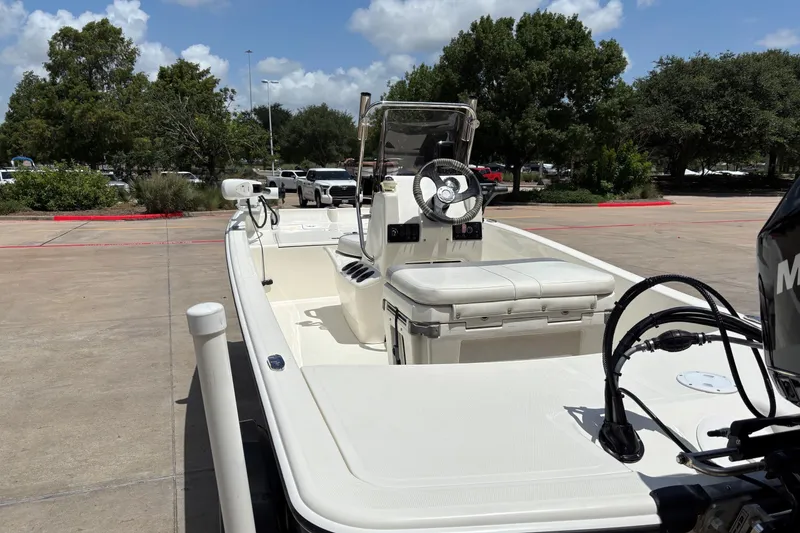 Slide: The Image of 2021 Mako Pro Skiff 15 CC boat parked outdoors on a sunny day. - 2