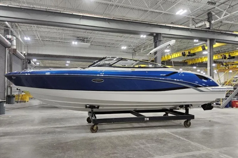The Image of 2027 Formula 270 Bowrider boat in a spacious indoor facility, showcasing sleek blue design. - 0