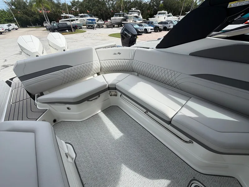 Slide: The Image of The image shows the sleek, upholstered aft seating of a Sea Ray SLX 280 Outboard boat. - 13