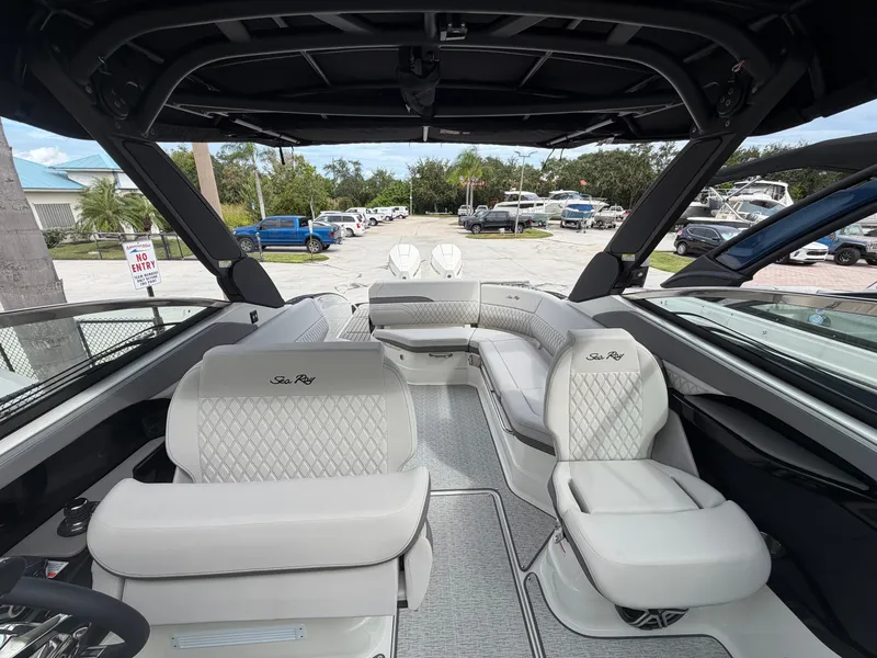 Slide: The Image of The image shows the cockpit of a Sea Ray SLX 280 Outboard with luxurious white upholstered seats. - 32