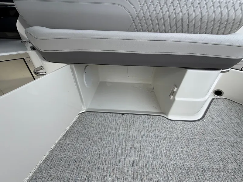 Slide: The Image of A sleek storage compartment beneath a cushioned seat on a boat. - 33