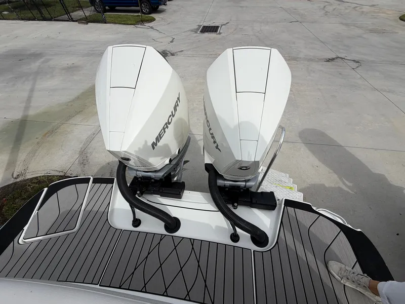Slide: The Image of Two Mercury outboard engines on a Sea Ray SLX 280 boat, parked on a paved area. - 6