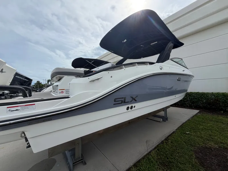 Slide: The Image of A 2027 Sea Ray SLX 280 Outboard on a stand. It features a sleek, modern design. - 1
