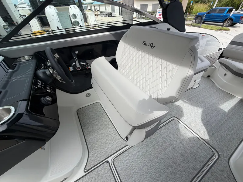 Slide: The Image of The image shows the interior of a Sea Ray SLX 280 Outboard with sleek white seating. - 19
