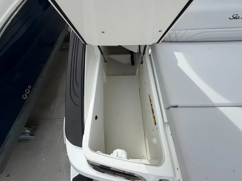 Slide: The Image of An open storage compartment on a Sea Ray SLX 280 Outboard boat, revealing a spacious interior. - 8