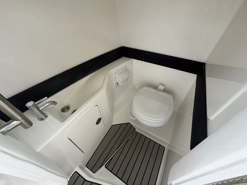 Slide: The Image of The image shows a compact boat toilet with a sink and storage space. - 23