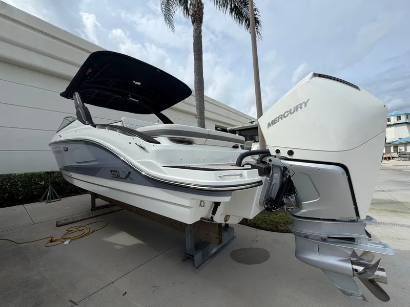 Slide: The Image of A 2027 Sea Ray SLX 280 Outboard on a stand. The outboard motor is by Mercury. - 4