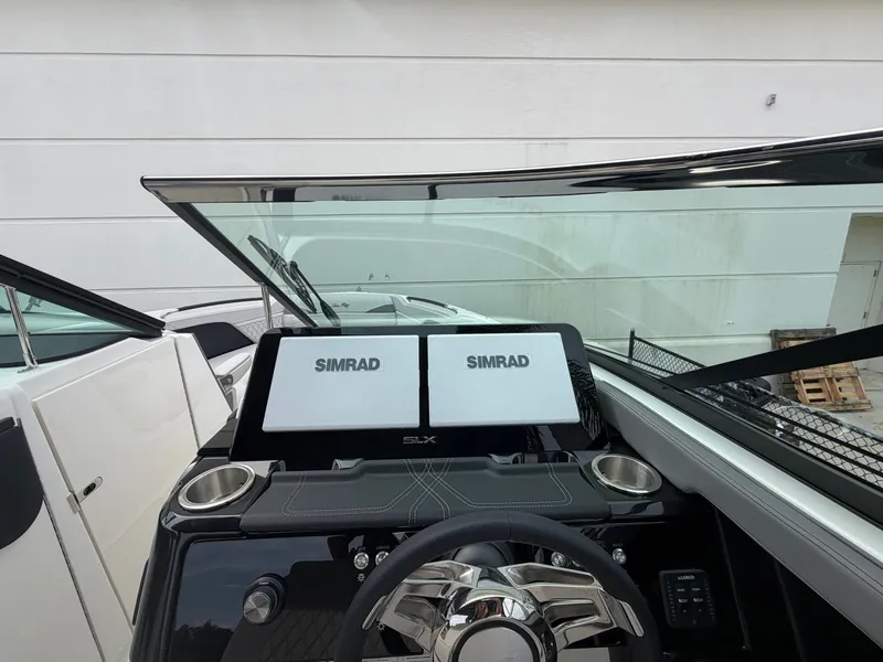 Slide: The Image of The image shows the cockpit of a Sea Ray SLX 280 Outboard with two Simrad displays. - 22