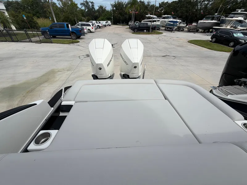 Slide: The Image of Rear view of a Sea Ray SLX 280 Outboard with twin engines, in a lot with other boats. - 35