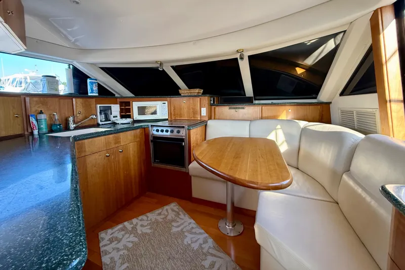 Slide: The Image of Interior of 2000 Silverton 453 Motor Yacht with kitchen and dining area. - 12