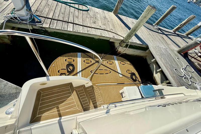 Slide: The Image of 2000 Silverton 453 Motor Yacht docked, showcasing teak swim platform and steps. - 3