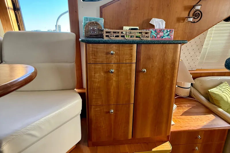Slide: The Image of Interior of 2000 Silverton 453 Motor Yacht with wooden cabinetry and seating area. - 17