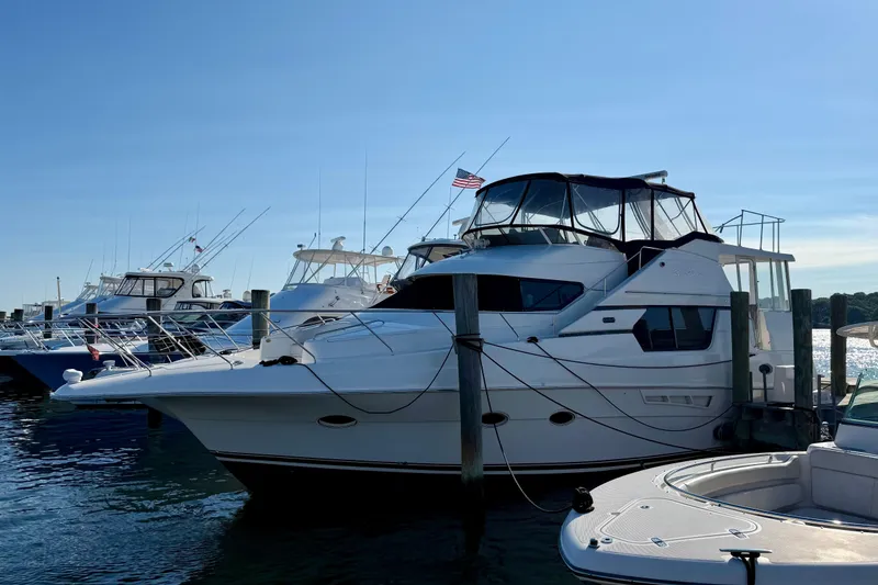 The Image of 2000 Silverton 453 Motor Yacht docked at marina under clear blue sky. - 0
