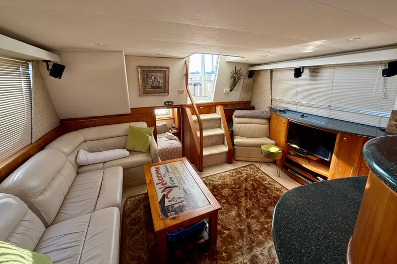 Slide: The Image of Luxurious interior of 2000 Silverton 453 Motor Yacht with plush seating and entertainment area. - 10