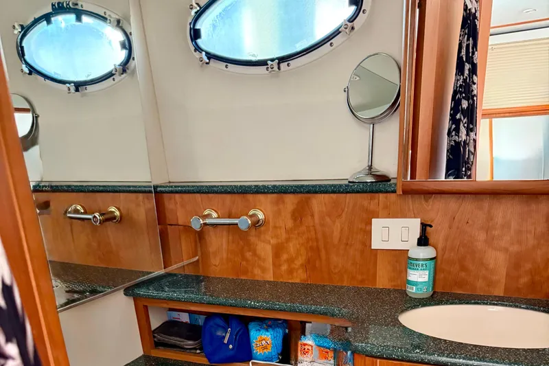 Slide: The Image of Bathroom interior of 2000 Silverton 453 Motor Yacht with porthole and vanity mirror. - 26