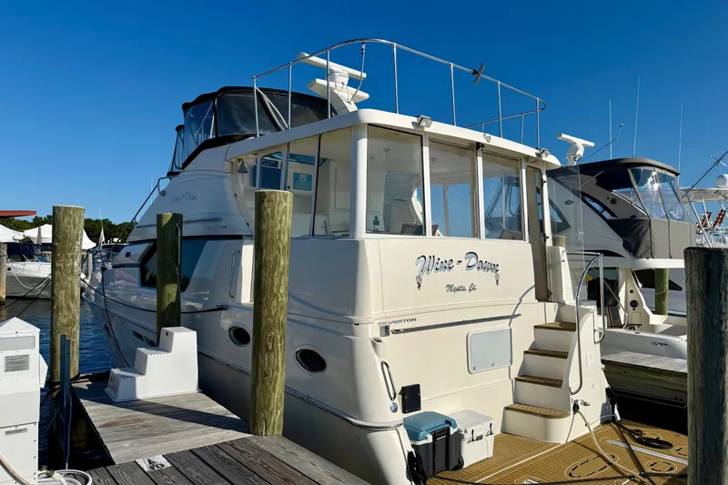 Slide: The Image of 2000 Silverton 453 Motor Yacht docked at marina under clear blue sky. - 1