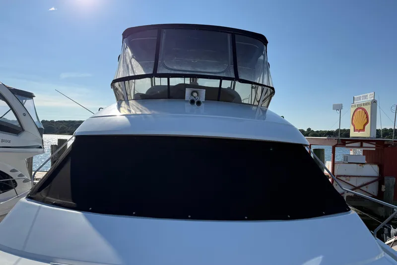 Slide: The Image of Front view of a 2000 Silverton 453 Motor Yacht docked at a marina. - 5