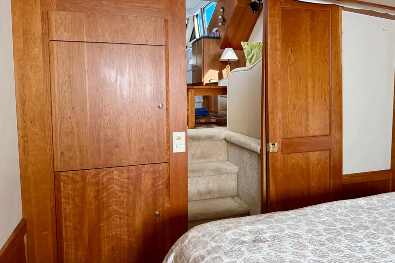 Slide: The Image of Interior of 2000 Silverton 453 Motor Yacht with wooden cabinetry and carpeted stairs. - 20