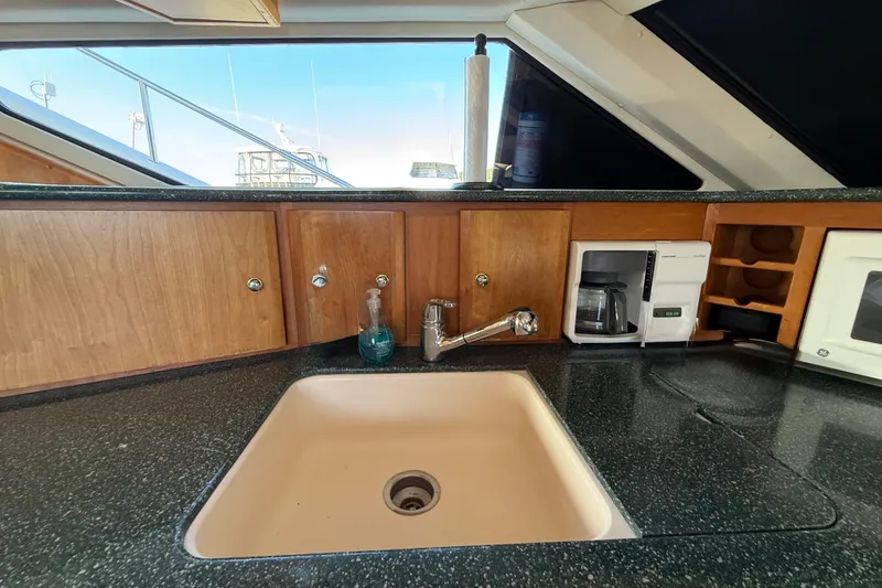 Slide: The Image of Kitchen area of 2000 Silverton 453 Motor Yacht with sink and coffee maker. - 16