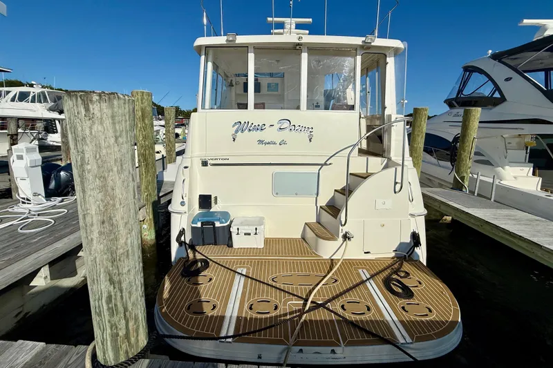 Slide: The Image of 2000 Silverton 453 Motor Yacht docked, featuring spacious deck and elegant design. - 2