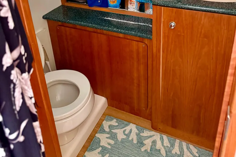 Slide: The Image of Bathroom interior of 2000 Silverton 453 Motor Yacht with wooden cabinetry and marine toilet. - 22