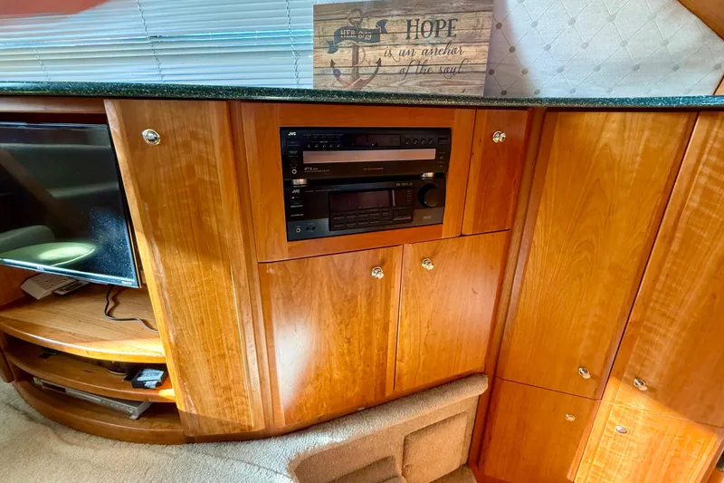 Slide: The Image of Interior of 2000 Silverton 453 Motor Yacht with wooden cabinetry and stereo system. - 18