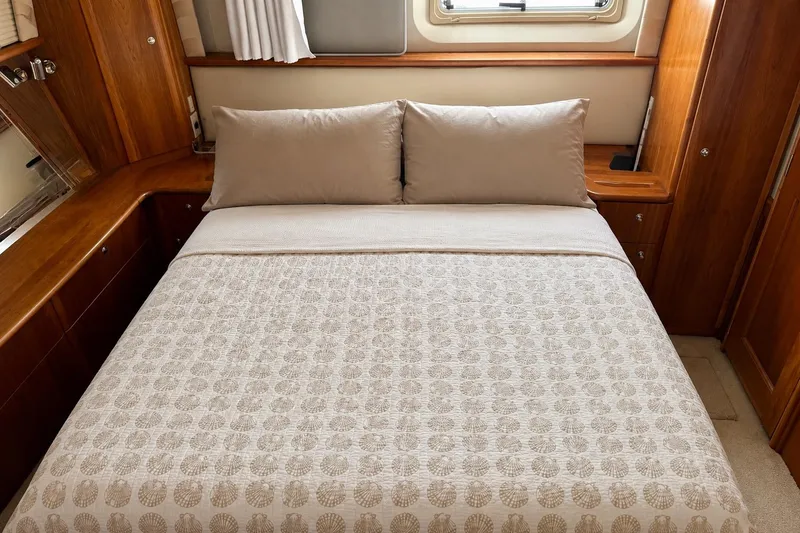 Slide: The Image of Luxurious bedroom interior of 2000 Silverton 453 Motor Yacht with elegant bedding and wood accents. - 19