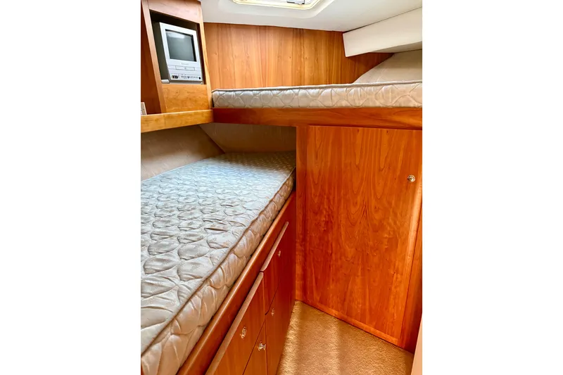 Slide: The Image of 2000 Silverton 453 Motor Yacht interior with wooden cabinetry and bunk beds. - 25