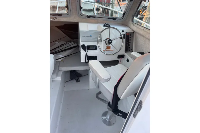 Slide: The Image of Interior of 2023 Parker 2320 SL Sport Cabin with steering wheel and Garmin navigation system. - 7