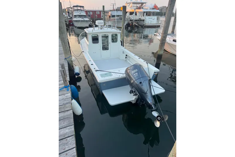 Slide: The Image of 2023 Parker 2320 SL Sport Cabin boat docked with Yamaha 300 V6 engine. - 9