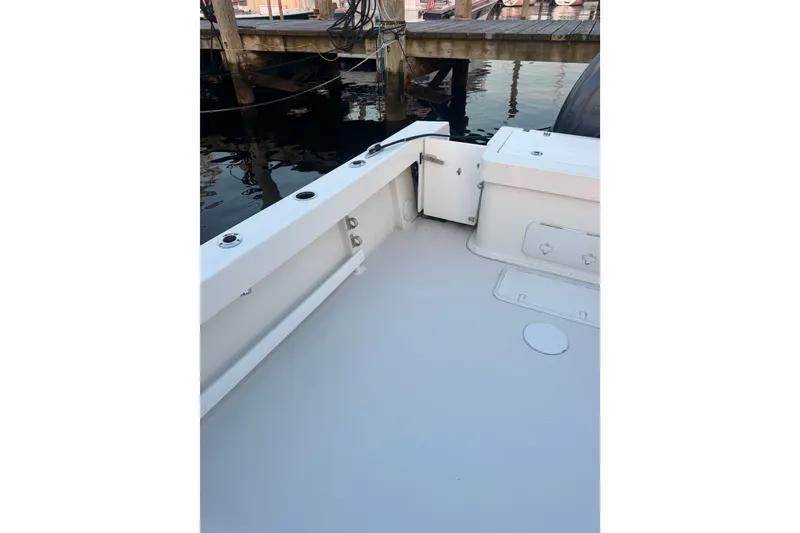 Slide: The Image of 2023 Parker 2320 SL Sport Cabin boat deck near dock, showcasing spacious layout. - 4