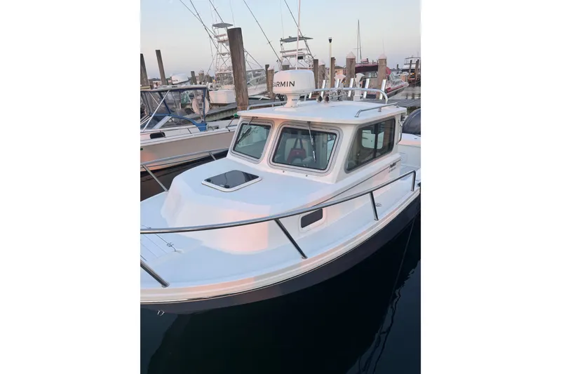 Slide: The Image of 2023 Parker 2320 SL Sport Cabin boat docked at marina, showcasing sleek design. - 8