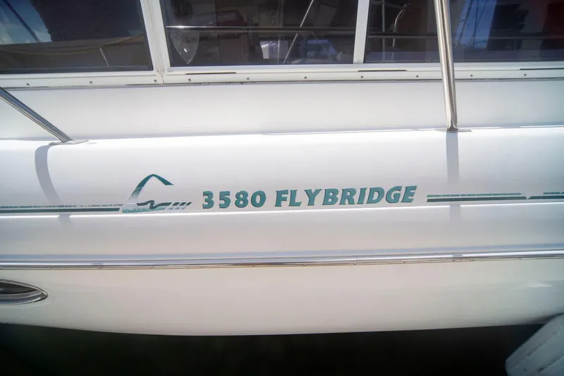 Slide: The Image of 1996 CRUISERS YACHTS 3580 Flybridge, white exterior with model name displayed. - 24
