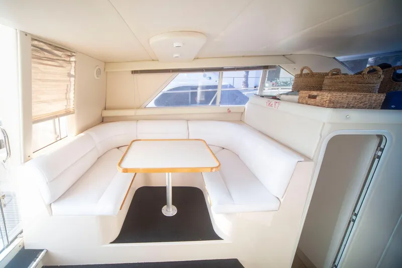 Slide: The Image of Interior of 1996 CRUISERS YACHTS 3580 Flybridge with white seating and table. - 51