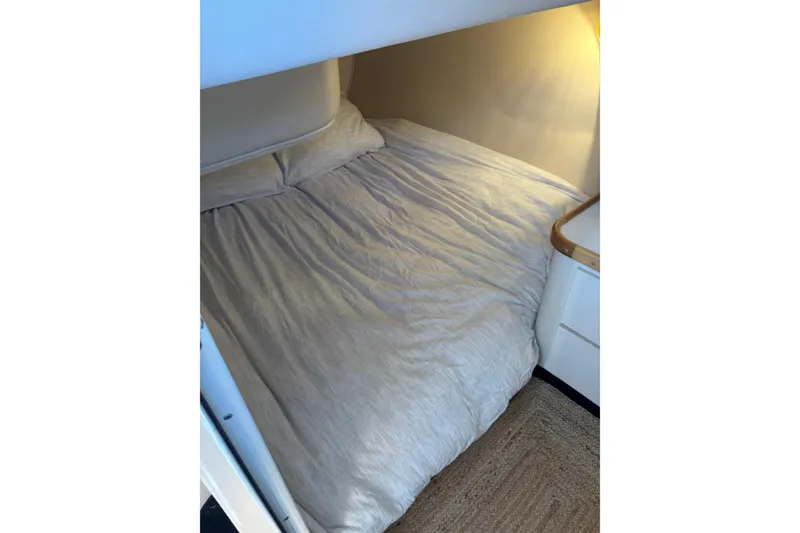 Slide: The Image of Cozy cabin bedroom in 1996 Cruisers Yachts 3580 Flybridge with soft lighting. - 63