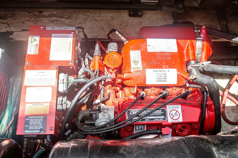 Slide: The Image of Engine compartment of a 1996 CRUISERS YACHTS 3580 Flybridge, featuring a Westerbeke generator. - 36