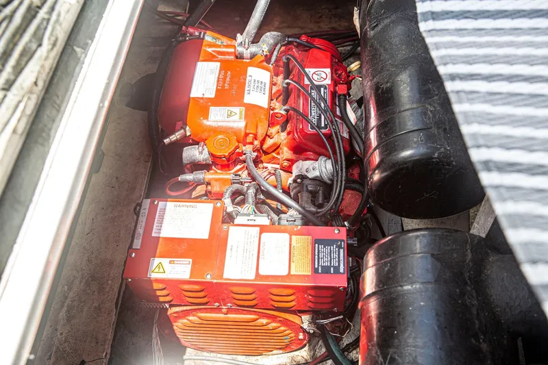 Slide: The Image of Engine compartment of 1996 CRUISERS YACHTS 3580 Flybridge, featuring red engine components. - 35