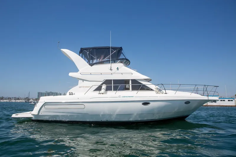 The Image of 1996 CRUISERS YACHTS 3580 Flybridge on water, showcasing sleek design and spacious flybridge. - 0