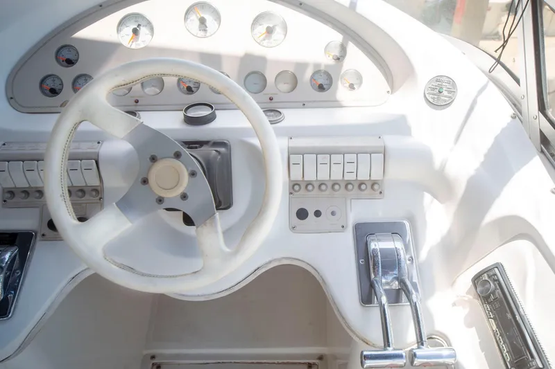 Slide: The Image of 1996 CRUISERS YACHTS 3580 Flybridge helm with steering wheel and control panel. - 39