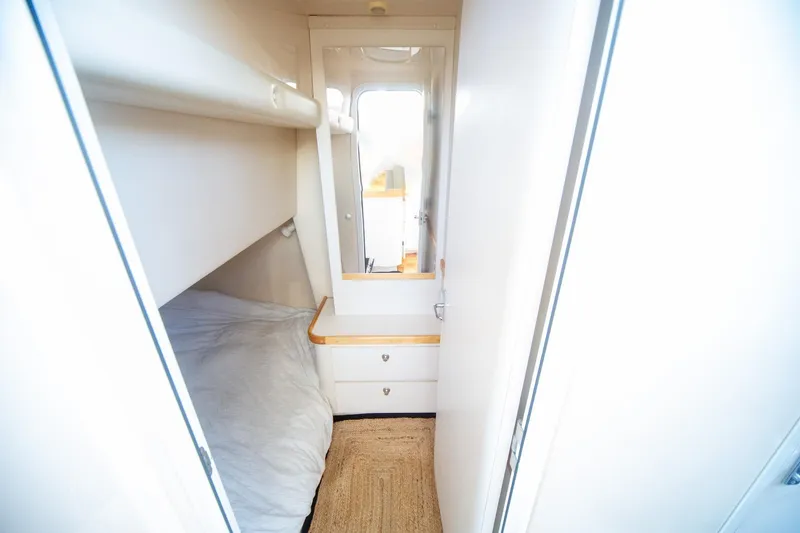 Slide: The Image of Interior cabin of 1996 CRUISERS YACHTS 3580 Flybridge with cozy bed and storage. - 59