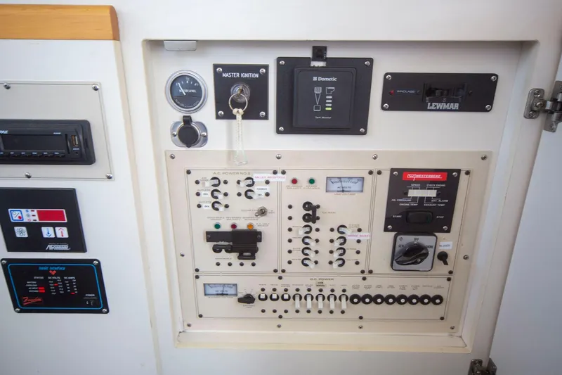 Slide: The Image of Control panel of a 1996 CRUISERS YACHTS 3580 Flybridge, featuring various switches and gauges. - 29