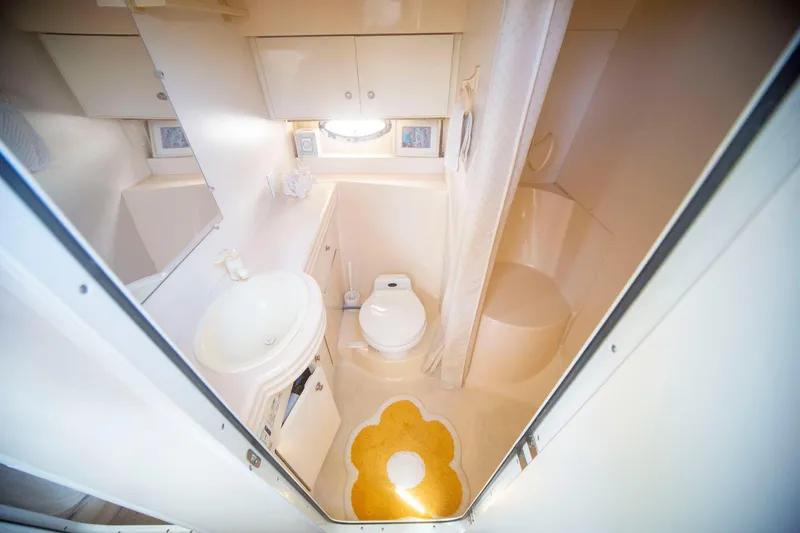 Slide: The Image of Bathroom interior of 1996 CRUISERS YACHTS 3580 Flybridge, featuring sink, toilet, and shower. - 57