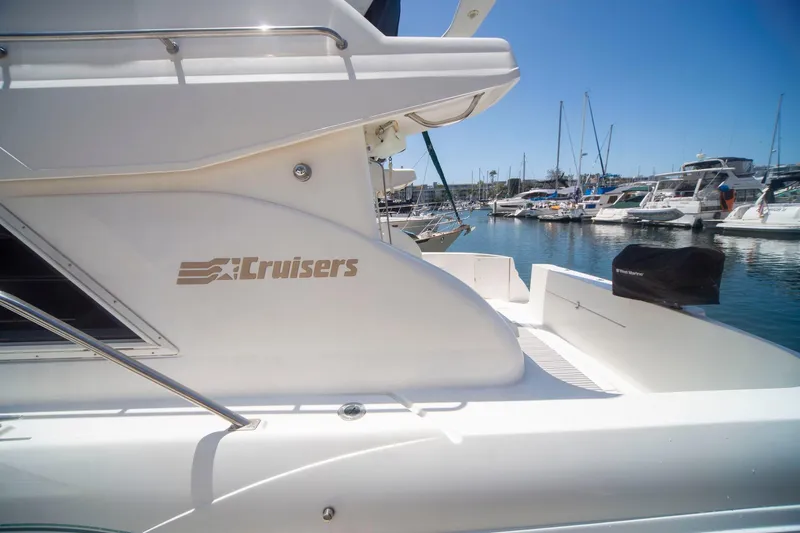 Slide: The Image of 1996 Cruisers Yachts 3580 Flybridge docked in a sunny marina. - 23
